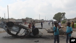 FILE - A burnt out vehicle lays on its roof in Lusaka, Zambia, April 7, 2016.