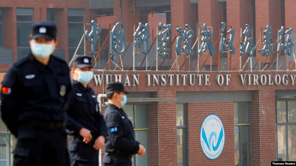 Security personnel keep watch outside Wuhan Institute of Virology during a visit by the World Health Organization (WHO) team tasked with investigating the origins of the coronavirus disease (COVID-19), in Wuhan, Hubei province, China February 3, 2021. (REUTERS/Thomas Peter)