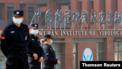 Security personnel keep watch outside Wuhan Institute of Virology during a visit by the World Health Organization (WHO) team tasked with investigating the origins of the coronavirus disease (COVID-19), in Wuhan, Hubei province, China February 3, 2021. (REUTERS/Thomas Peter)