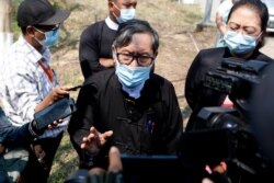 Khin Maung Zaw, center, a lawyer assigned by the National League for Democracy party to represent deposed Myanmar leader Aung San Suu Kyi, speaks to journalists outside the Zabuthiri Township Court in Naypyitaw, Myanmar, Monday, March 1.