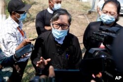 Khin Maung Zaw, center, a lawyer assigned by the National League for Democracy party to represent deposed Myanmar leader Aung San Suu Kyi, speaks to journalists outside the Zabuthiri Township Court in Naypyitaw, Myanmar, Monday, March 1.