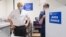 FILE - British Prime Minister Boris Johnson watches as a dose of the AstraZeneca COVID-19 vaccine is prepared by a nurse, at a coronavirus vaccination site in north London, Britain, Jan. 25, 2021.