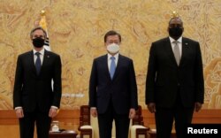 FILE - South Korean President Moon Jae-in poses for a photo with U.S. Secretary of State Antony Blinken and U.S. Defense Secretary Lloyd Austin during their meeting at the presidential Blue House in Seoul, South Korea, March 18, 2021.