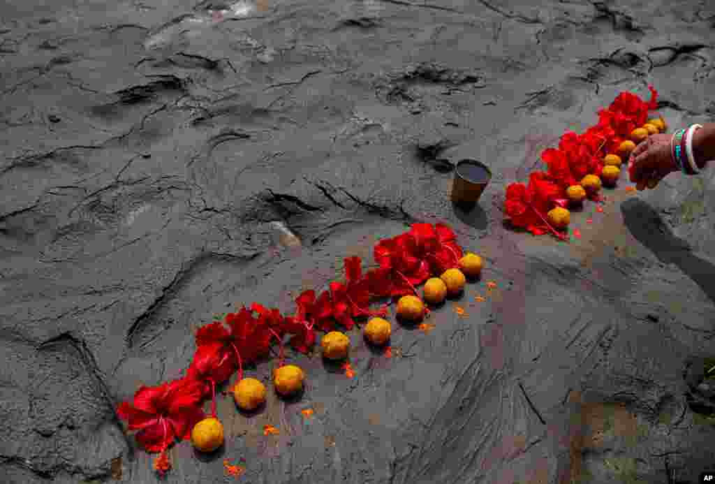 A Hindu woman performs rituals during a prayer ceremony to rid the world of coronavirus, on the banks of the river Brahmaputra in Gauhati, India.