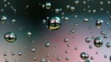 Raindrops on a car window reflect a man walking past a stock index board in Tokyo, Japan.<br />
&nbsp;