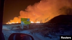 A volcano spews lava and smoke as it erupts, near Grindavik, Iceland, Feb. 8, 2024 in this still image obtained from social media video. (Marc Gibbons via REUTERS).