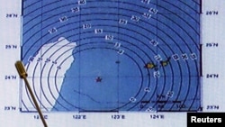 Japan Meteorological Agency's earthquake and volcano observations division director Koji Nakamura (not in picture) points on the map showing the earthquake center (star mark) during a news conference in Tokyo, April 20, 2015. 