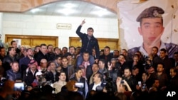 Supporters and family members of Jordanian pilot, Lt. Muath al-Kaseasbeh, express their anger at his reported killing in Amman, Jordan, February, 3, 2015.