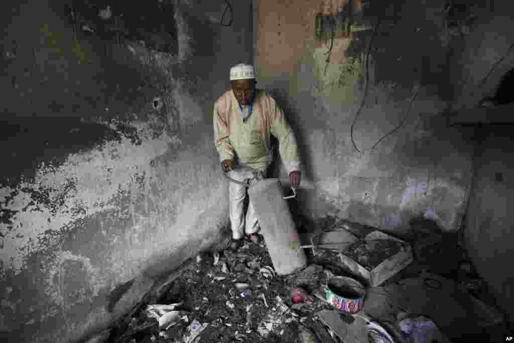 An unidentified official displays burnt equipment inside a prison in Bauchi, Nigeria, Thursday, Sept. 9, 2010, after the radical Muslim Boko Haram sect armed with assault rifles launched an attack at sunset on Tuesday Sept. 7, on the prison to free more