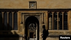 FILE - A student walks on the campus of Oxford University, amid the coronavirus pandemic, in Oxford, Britain, Sept. 17, 2020.