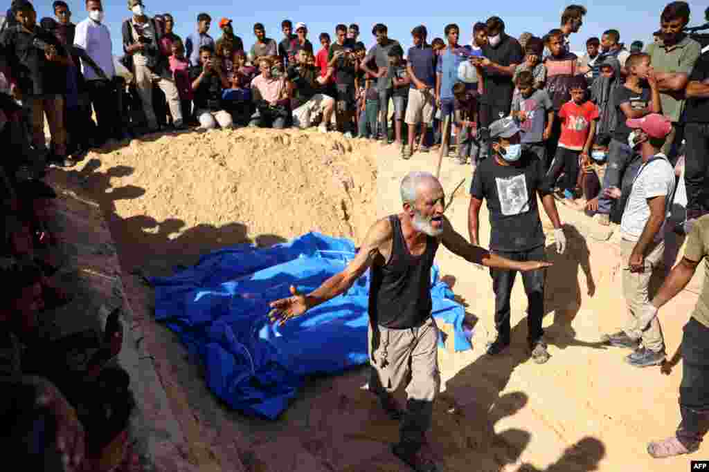 A man reacts as others gather to watch the burial of some of the 88 bodies in a mass grave in Khan Yunis on Sept. 26, 2024, which according to the Palestinian health ministry, entered the Gaza Strip from Israel the day before.