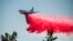 FILE - In this July 2, 2021, file photo a DC-10 air tanker drops retardant while battling the Salt Fire near the Lakehead, Calif. 
