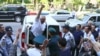 FILE - Azerbaijani journalist Afgan Mukhtarli greets supporters as he is taken to court in Baku, Azerbaijan, May 31, 2017.