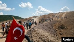 Environmental activists take part in a march to protest against what they say will be pollution from a foreign-owned gold mine project near the western town of Kirazli in Canakkale province, Turkey, Aug. 5, 2019. 