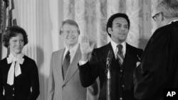 FILE - Andrew Young is sworn in as United Nations ambassador by Associate Justice Thurgood Marshall, as President Jimmy Carter looks on at the White House, Jan. 31, 1977 in Washington.