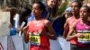 FILE - Buzunesh Deba, left, of Ethiopia, runs in a group of elite female participants past Wellesley College during the 118th Boston Marathon in Wellesley, Mass., April 21, 2014.