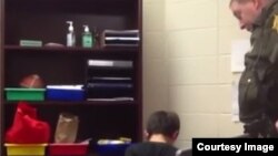 A screengrab from the video showing officer Kevin Sumner handcuffing one of the students.