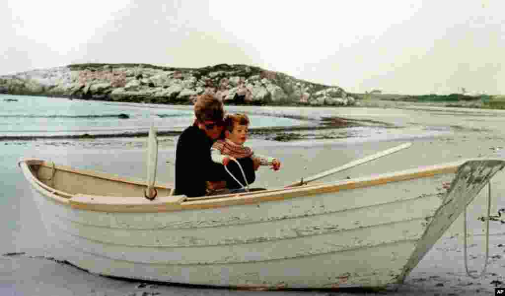 This is a Sept.14, 1963 photo of John F. Kennedy Jr. receiving an early introduction to boats at the hands of his father, President John Fitzgerald Kennedy at Bailey's Beach in Newport, R.I. On Thursday, July 22, 1999 the ashes of Kennedy Jr., his wife, 