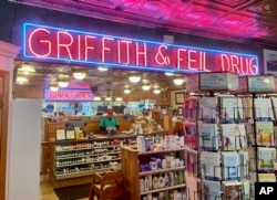 A man works behind the pharmacy counter at Griffith & Feil Drug on Thursday, March 30, 2023, in Kenova, W. Va. Soda fountains were often in pharmacies because pharmacists mixed tonics meant to heal ailments. (AP Photo/John Raby)