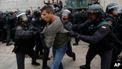 Des gardes civiles empêchent des personnes d'aller voter à Sant Julia de Ramis, près de Girona, en Espagne, le 1er octobre , 2017.