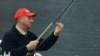 FILE - Former England cricketer Ian Botham casts his line on Loch Tay at Kenmore, on the opening day of the salmon season, Jan. 15, 2001.