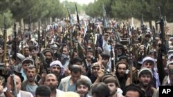 En esta foto del 23 de junio de 2021, milicianos afganos se unen a las fuerzas de seguridad y defensa afganas durante una reunión en Kabul, Afganistán. Funcionarios estadounidenses dijeron a The Associated Press que se espera que unas 650 tropas estadouni