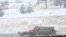 A snowplow patrols U.S. Interstate 70 in Colorado in the initial hours of a winter storm that meteorologists said could bring several feet of snow to parts of the state, March 13, 2021.