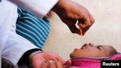 Seorang anak lelaki mendapatkan vaksinasi polio selama kampanye vaksinasi dari rumah ke rumah di Sanaa, Yaman (foto: REUTERS/Khaled Abdullah)