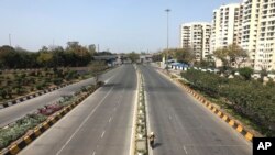 A commuter walks on a deserted street during a day long lockdown amid growing concerns of coronavirus, in New Delhi, India, March 22, 2020.