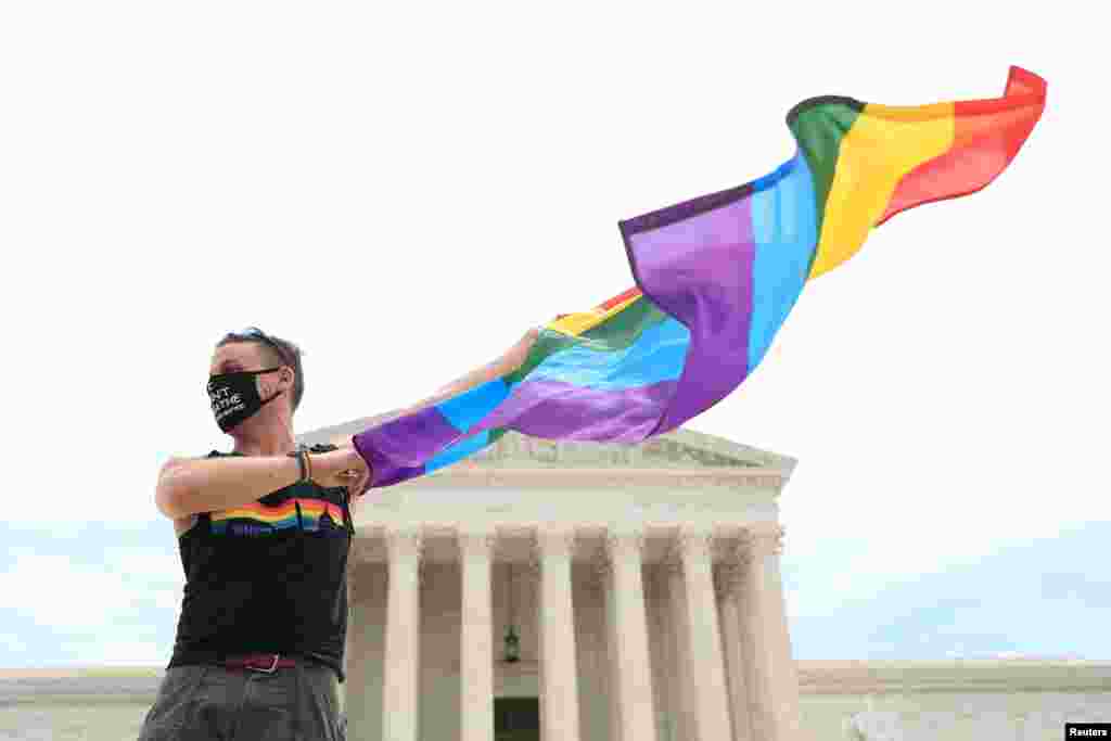 Joseph Fons holding a Pride Flag, stands in front of the U.S. Supreme Court building after the court ruled that a federal law banning workplace discrimination also covers sexual orientation, in Washington, D.C.