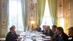 French President Nicolas Sarkozy, left, speaks during a special meeting on the financial crisis at the Elysee Palace in Paris, August 10, 2011