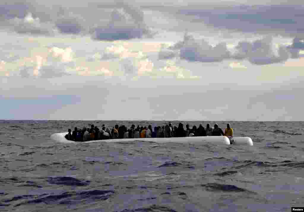 An overcrowded raft drifts out of control in the central Mediterranean Sea, some 36 nautical miles off the Libyan coast, before lifeguards from the Spanish NGO Proactiva Open Arms rescue all 112 on aboard, including two pregnant women and five children.