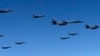 In this photo provided by South Korea Defense Ministry, U.S. Air Force B-1B bombers, F-35B stealth fighter jets and South Korean F-15K fighter jets fly over the Korean Peninsula during a joint drill on Sept. 18, 2017.