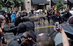 Police officers use pepper spray towards counter-demonstrators during a white nationalist-led rally marking the one year anniversary of the 2017 Charlottesville ‘Unite the Right’ protests, in Washington, U.S., August 12, 2018.