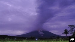 Volcanic materials spew from the crater of Mount Semeru in Lumajang, East Java, Indonesia, Dec. 1, 2020. 