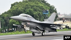 FILE - An U.S.-made F-16V fighter jet lands on the freeway in Changhua county, central Taiwan, May 28, 2019. 