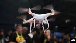 FILE - An exhibitor demonstrates a drone flight at CES International, in Las Vegas, Jan. 5, 2017.