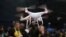 FILE - In this Jan. 5, 2017 file photo, an exhibitor demonstrates a drone flight at CES International, in Las Vegas. President Donald Trump signed a memorandum permitting states, localities and tribes to craft their own pilot programs to test drones, Oct. 25, 2017.
