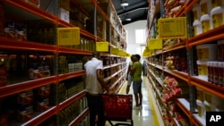 Shoppers walk through the aisles of a new bulk goods store in Havana, Cuba, Monday, July 11, 2016. 