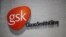 FILE - The logo of GlaxoSmithKline (GSK) is seen on its office building in Shanghai.