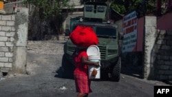 Residents evacuate the Solino district in Port-au-Prince on Nov. 16, 2024, a day after gangs took over the area. 