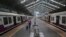A man wearing a mask walks through a deserted train station in Mumbai, India, March 22, 2020. 