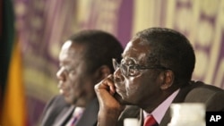 Zimbabwean President Robert Mugabe, right, with Prime Minister Morgan Tsvangirai, Harare, Nov. 11, 2011.