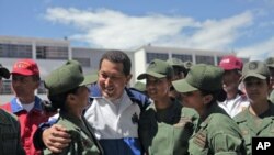 Venezuela's President Hugo Chavez (C) talks to soldiers as he attends a ceremony at the military academy in Caracas July 7, 2011