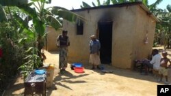 Residents cook food behind their homes in the Reconciliation Village