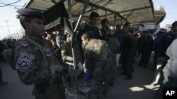 Policemen search Shi'ite pilgrims attending the religious ceremony of Arbain outside Imam al-Abbas shrine in Karbala, 80 km (50 miles) southwest of Baghdad, 24 Jan 2011