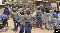 FILE: Armed Zimbabwean police battle rioters in Harare, Monday, July, 4, 2016.