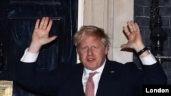Britain's Prime Minister Boris Johnson applauds outside 10 Downing Street during the Clap For Our Carers campaign in support of the NHS, as the spread of the coronavirus disease (COVID-19) continues, London, Britain, March 26, 2020. 