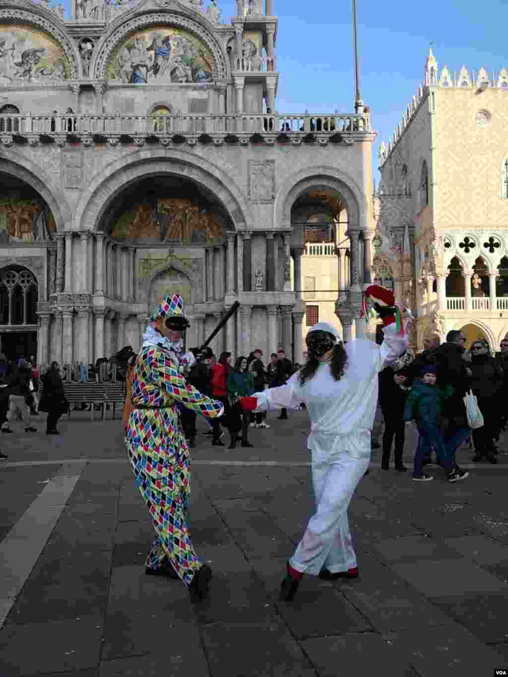 A couple in costume strike a pose at Saint Mark’s Square as the carnival was set to kick off, in Venice, Italy, Feb. 8, 2020.