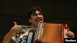 FILE - Mexican musician Celso Pina performs during the Santa Lucia International Festival in Monterrey, northern Mexico, Sept. 21, 2008. 
